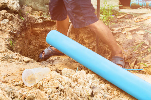 broken pipe in hole with water motion at roadside and plumber working repair broken pipe in hole with water motion at roadside and plumber working repair